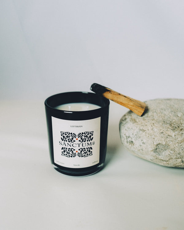 Hand-poured Sanctum Candle with palo santo incense, photographed on a white background to highlight its subtle, calming home fragrance and minimalist design.