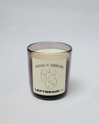 Hand-poured Smoke N' Mirrors Candle on a white background, highlighting its minimalist design and calming home fragrance.