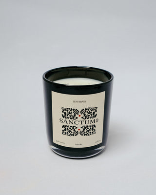 Hand-poured Sanctum Candle with palo santo incense, photographed on a white background to highlight its subtle, calming home fragrance and minimalist design.