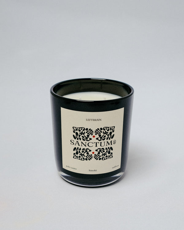 Hand-poured Sanctum Candle with palo santo incense, photographed on a white background to highlight its subtle, calming home fragrance and minimalist design.