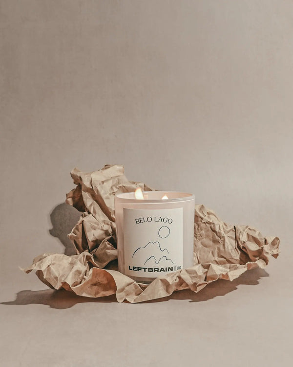 Hand-poured Belo Lago candle posed on craft paper against a neutral background, showcasing its warm, comforting scent and subtle home fragrance.